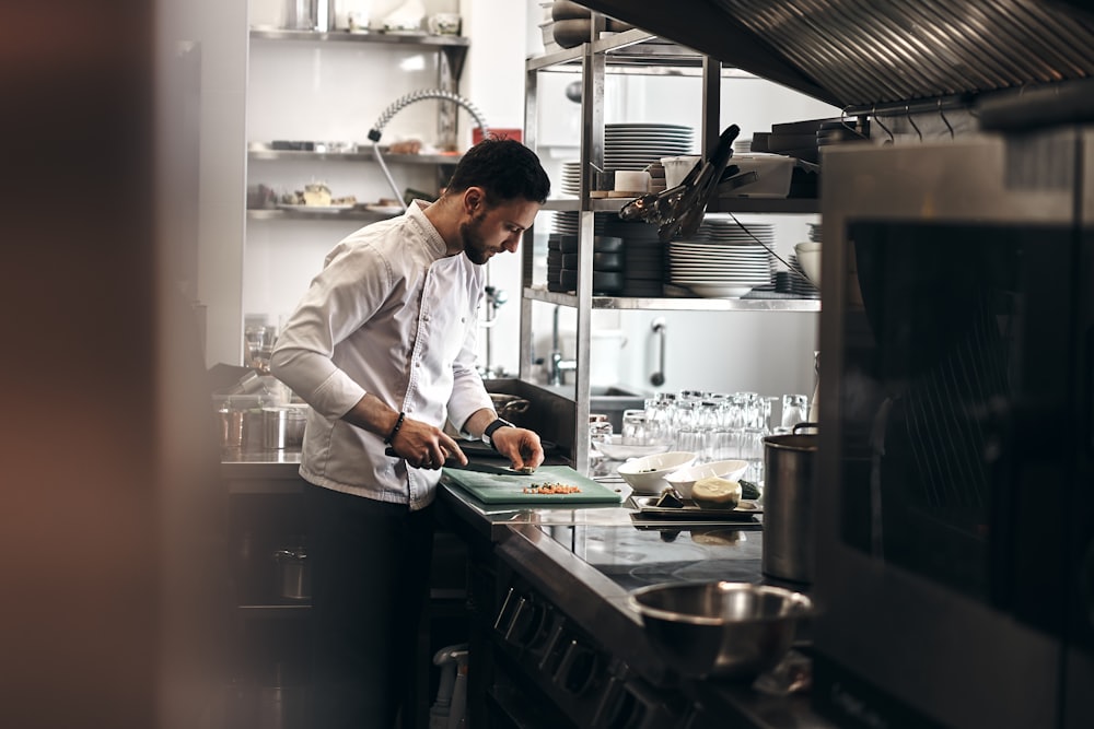 Chef plating a dish in a commercial kitchen