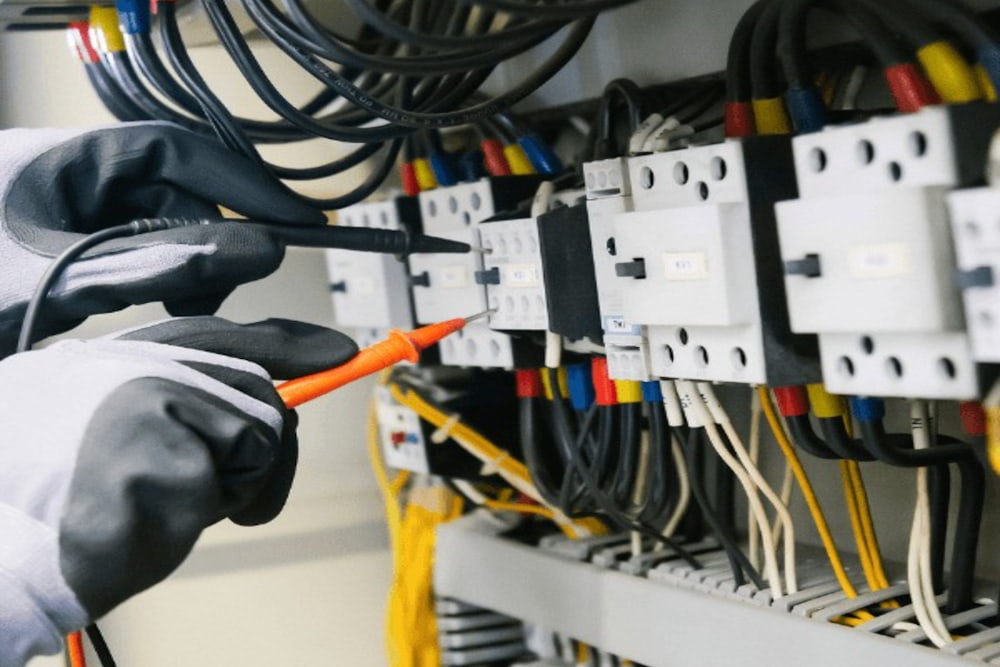 Electrician wiring a switchboard